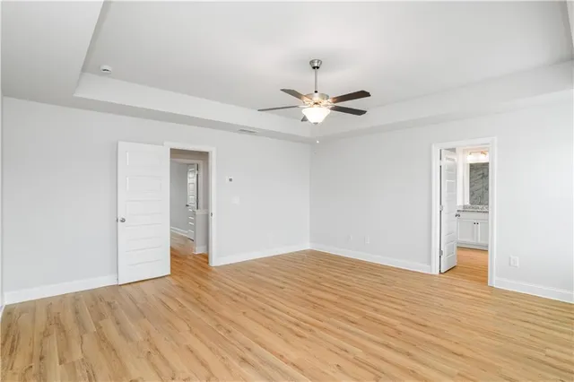 a view of an empty room with wooden floor
