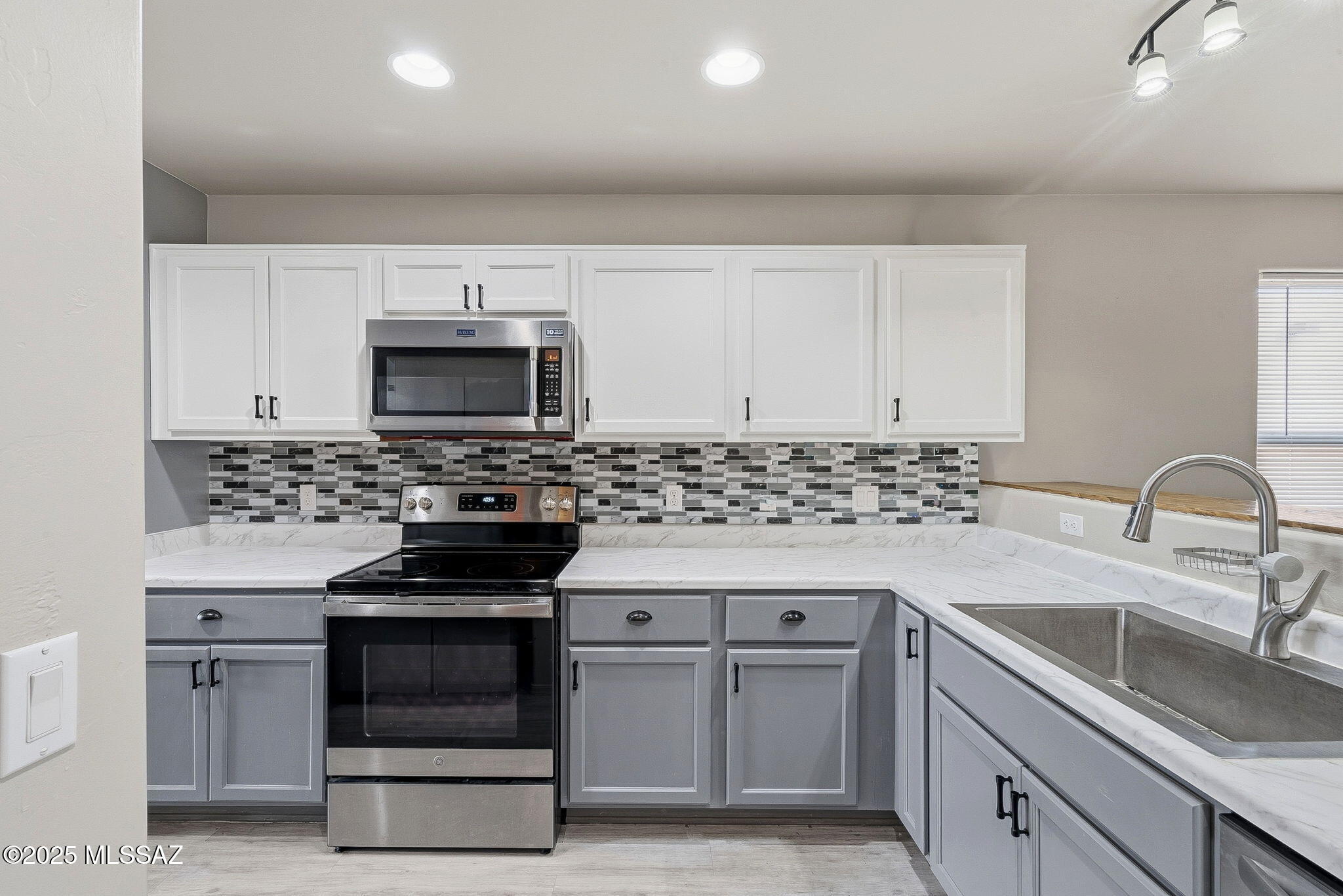1458 North Wentworth Road Vail, AZ 85641 - Photo 26 of 44 a kitchen with granite countertop white cabinets and stainless steel appliances