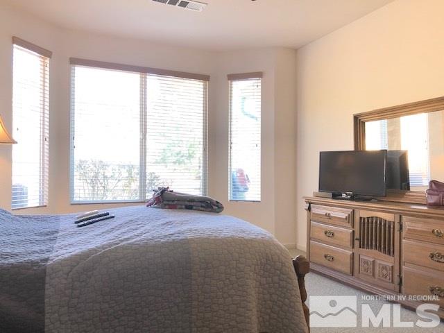 1310 Meridian Ranch Drive Reno, NV 89523 - Photo 6 of 13 a bedroom with furniture and flat screen tv