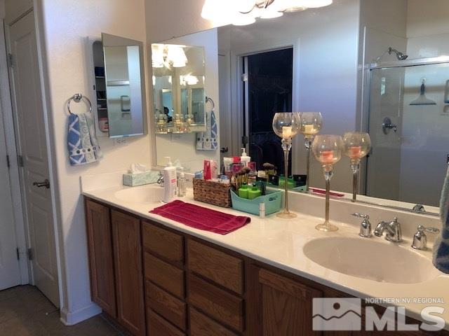 1310 Meridian Ranch Drive Reno, NV 89523 - Photo 7 of 13 a bathroom with a sink vanity and a mirror