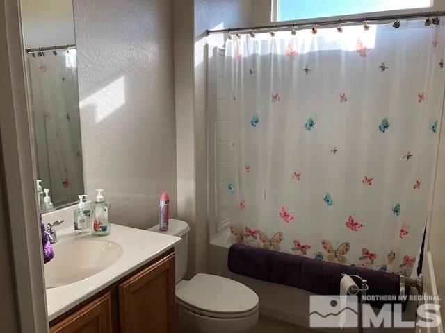 1310 Meridian Ranch Drive Reno, NV 89523 - Photo 9 of 13 a bathroom with a sink vanity mirror and toilet
