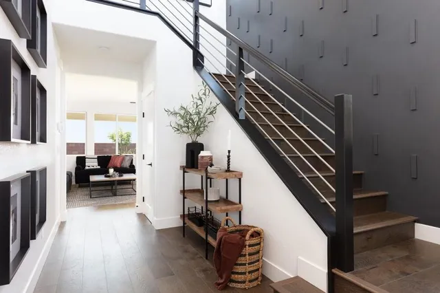 a view of entryway and hall with wooden floor