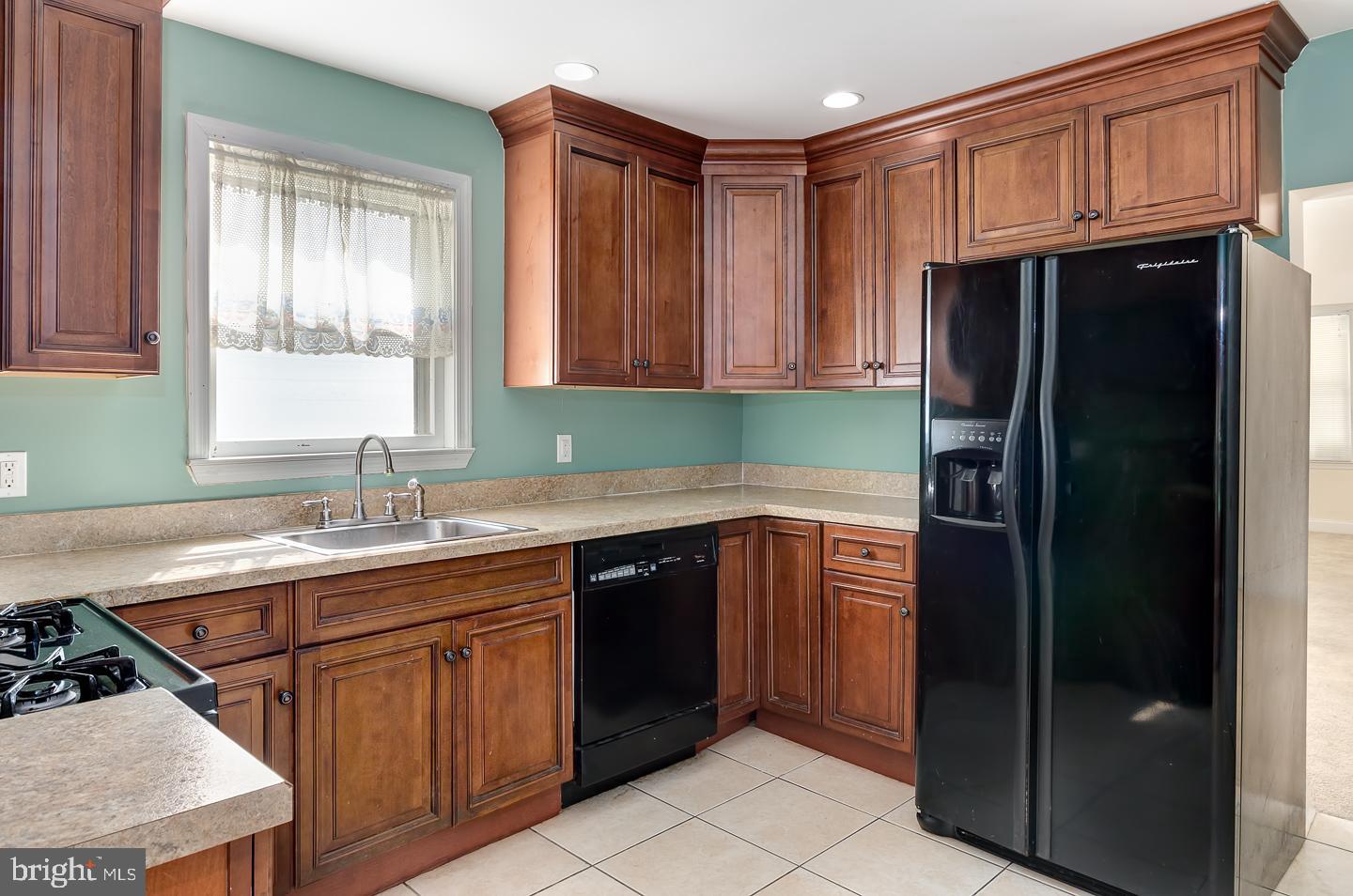 569 South Fairview Street Riverside, NJ 08075 - Photo 12 of 26 a kitchen with a sink stove and refrigerator