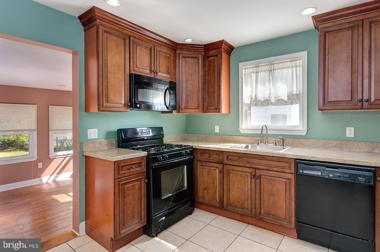569 South Fairview Street Riverside, NJ 08075 - Photo 13 of 26 a kitchen with stainless steel appliances granite countertop a stove sink and cabinets