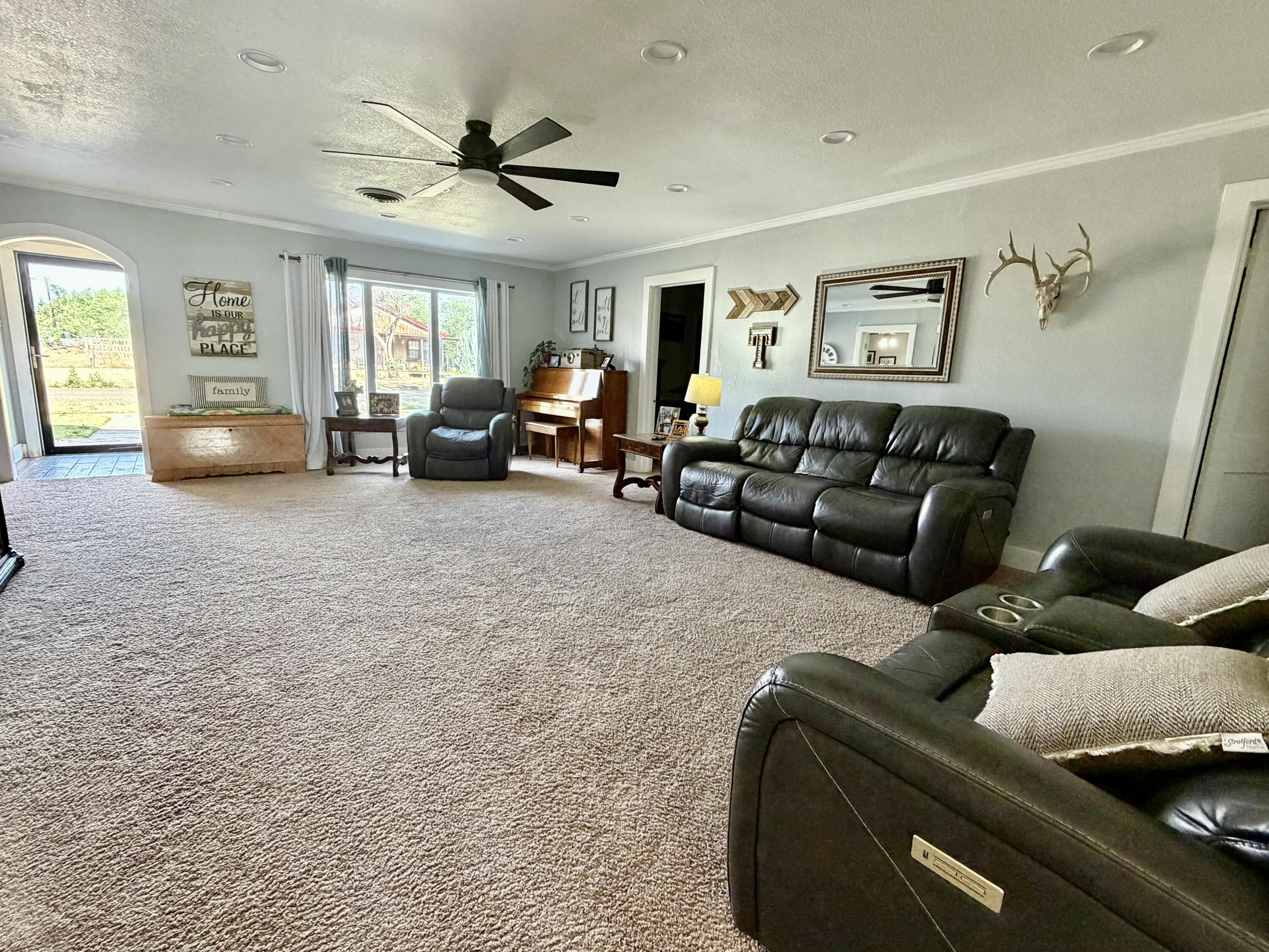 207 2nd Street Quitaque, TX 79255 - Photo 3 of 9 a living room with furniture and a window