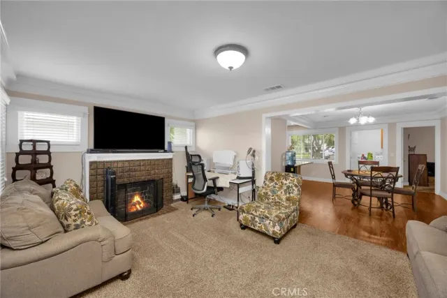 a living room with furniture flat screen tv and a fireplace