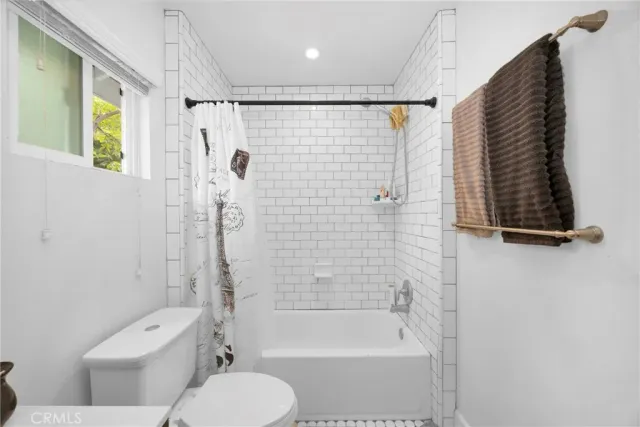 a bathroom with a shower a toilet and a shower