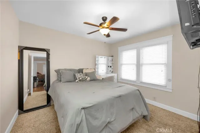 a bedroom with a large bed and a flat screen tv