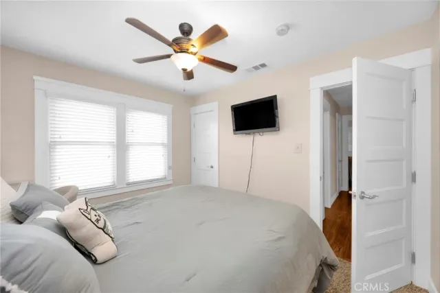 a bedroom with a bed and a flat screen tv