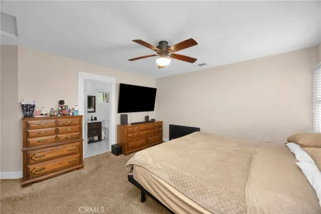 a bedroom with a bed and flat screen tv