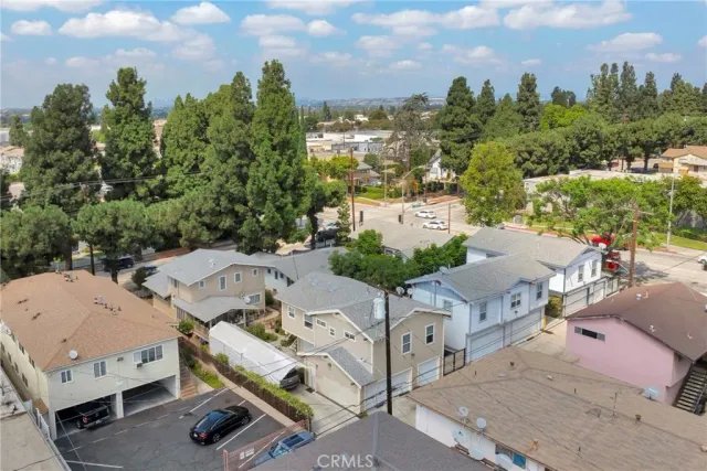 an aerial view of residential houses with outdoor space and street view