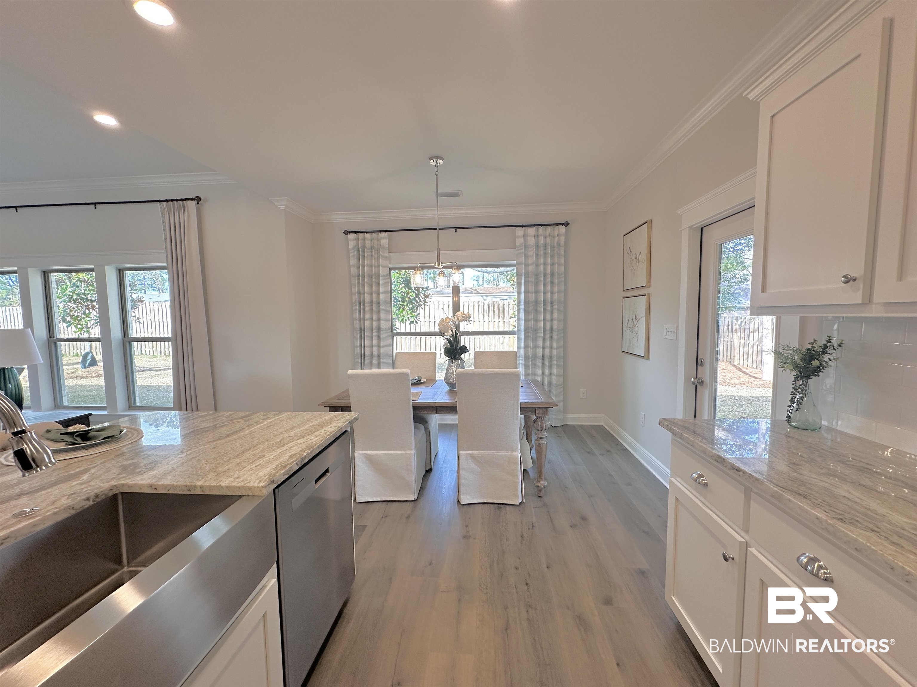 691 Kitfox Avenue Fairhope, AL 36532 - Photo 8 of 42 Kitchen featuring white cabinetry, light stone countertops, sink, and stainless steel dishwasher