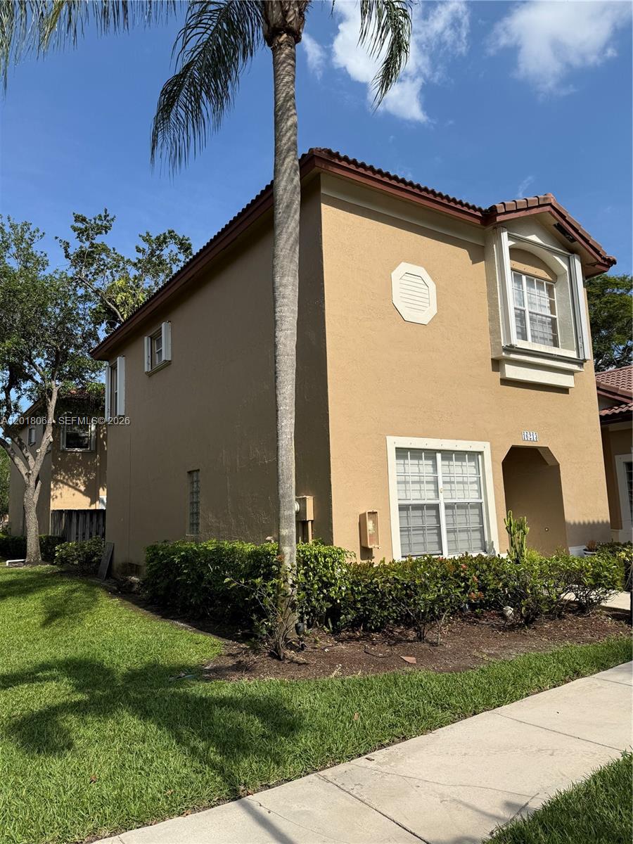 16213 Emerald Cove Road Weston, FL 33331 - Photo 20 of 27 a front view of a house with a yard
