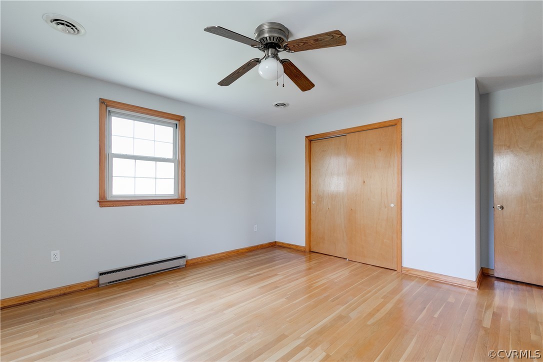 4440 Treely Road Chester, VA 23831 - Photo 27 of 39 an empty room with wooden floor ceiling fan and windows
