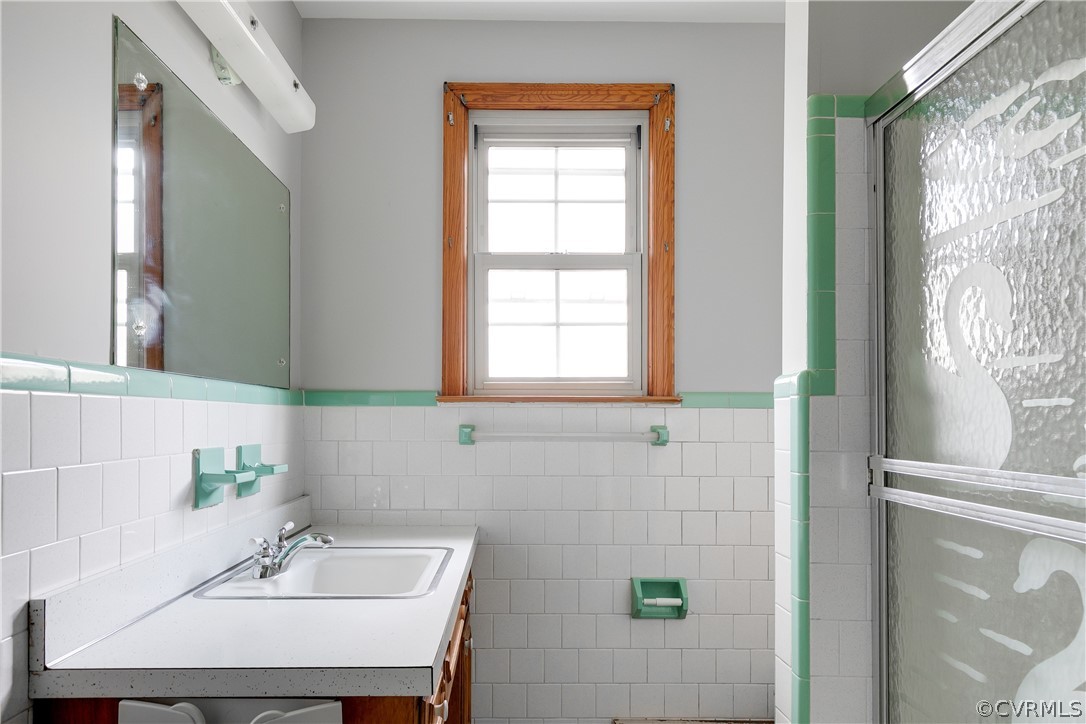 4440 Treely Road Chester, VA 23831 - Photo 29 of 39 a bathroom with a sink a mirror and a window