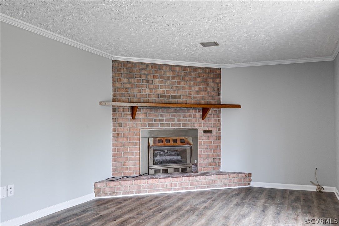 4440 Treely Road Chester, VA 23831 - Photo 32 of 39 a living room with a fireplace and a wooden floor