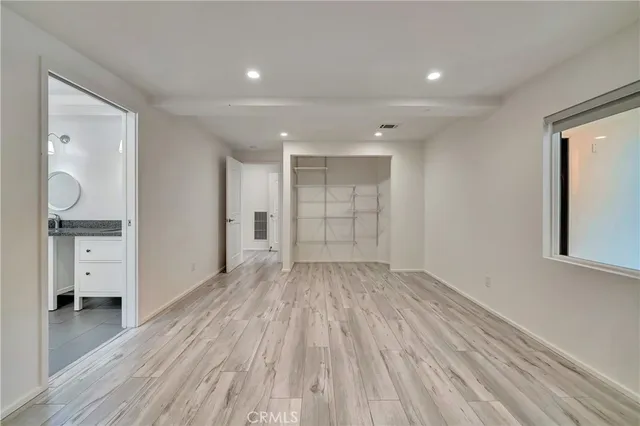 a bathroom with a granite countertop sink mirror vanity and toilet
