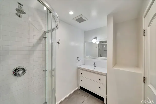 a bathroom with a glass shower door and a bathtub