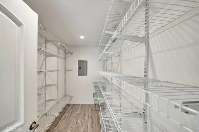 a backyard of a house with a wooden fence and large trees