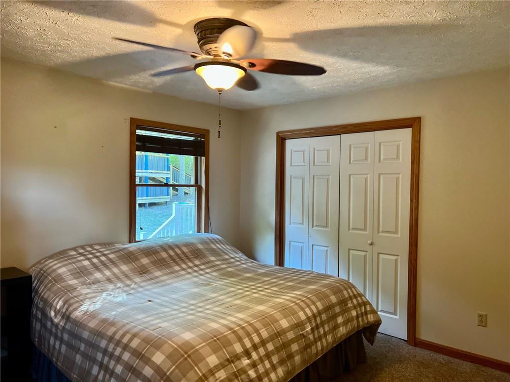 657 Fallecker Road Butler, PA 16002 - Photo 13 of 25 a bedroom with a bed and a chandelier