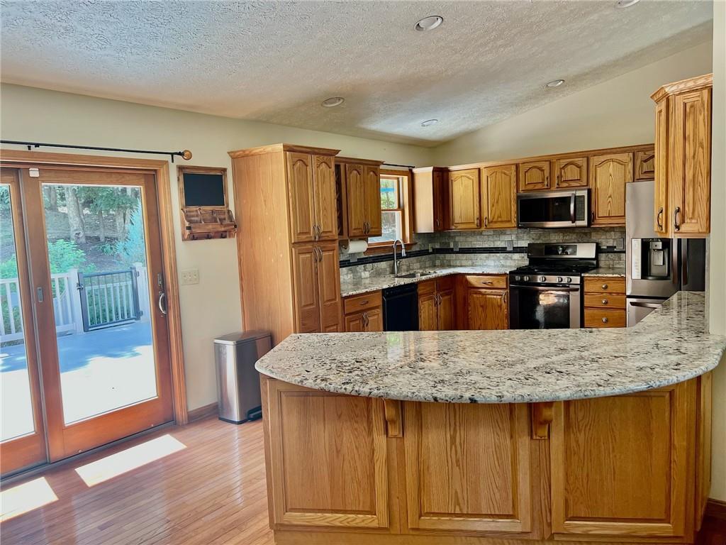 657 Fallecker Road Butler, PA 16002 - Photo 6 of 25 a kitchen with granite countertop a stove and a sink
