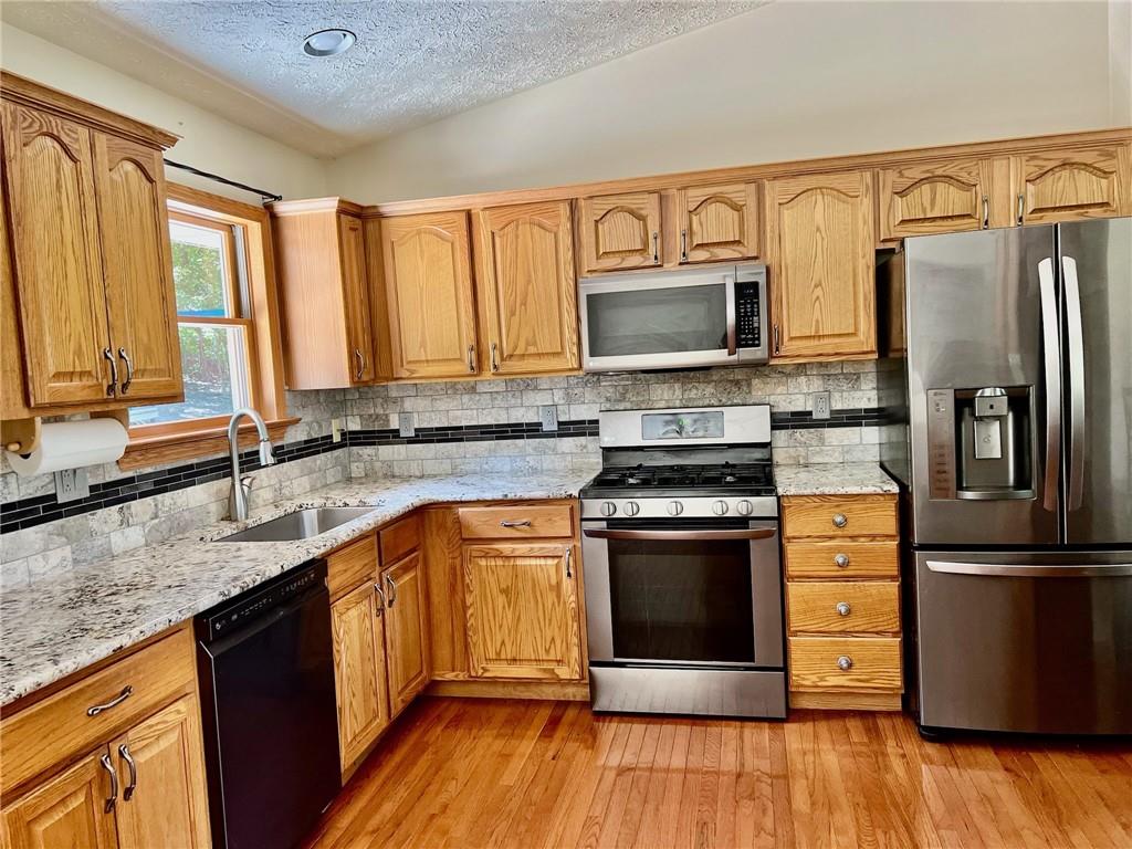657 Fallecker Road Butler, PA 16002 - Photo 7 of 25 a kitchen with stainless steel appliances granite countertop a refrigerator microwave and sink