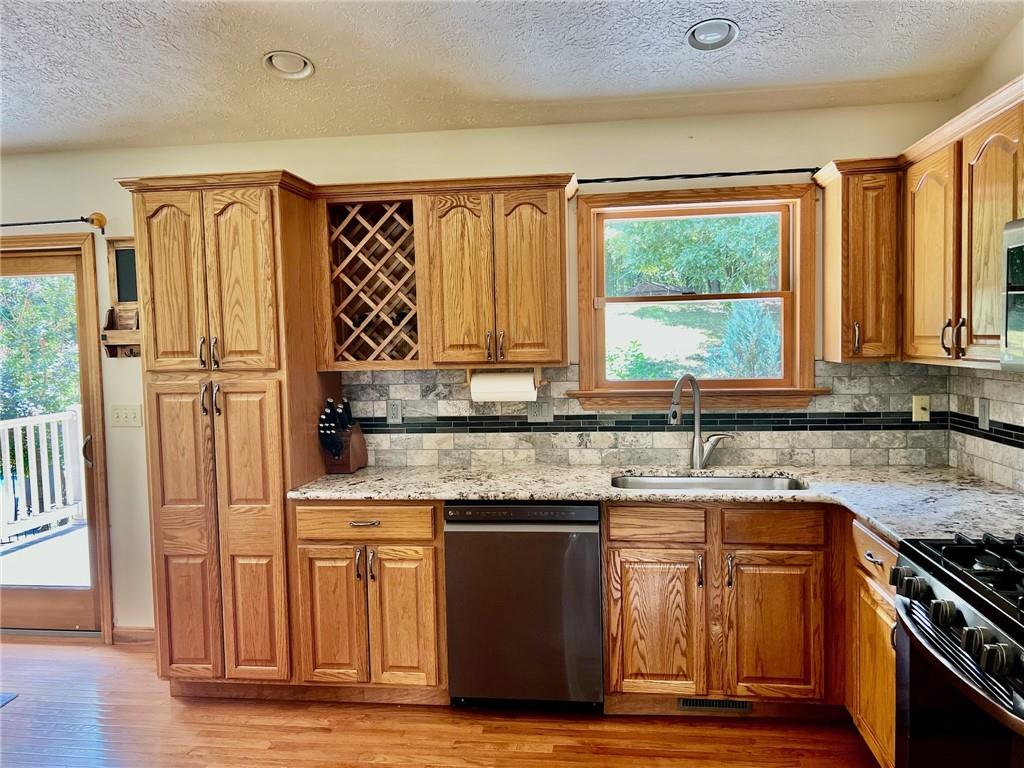 657 Fallecker Road Butler, PA 16002 - Photo 8 of 25 a kitchen with stainless steel appliances granite countertop a stove a sink and a microwave