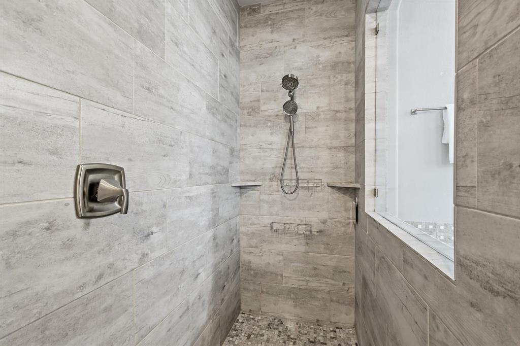 1933 Snapdragon Road Frisco, TX 75033 - Photo 22 of 40 Shower stall with large format wood-finish tile walls and a mosaic tile floor