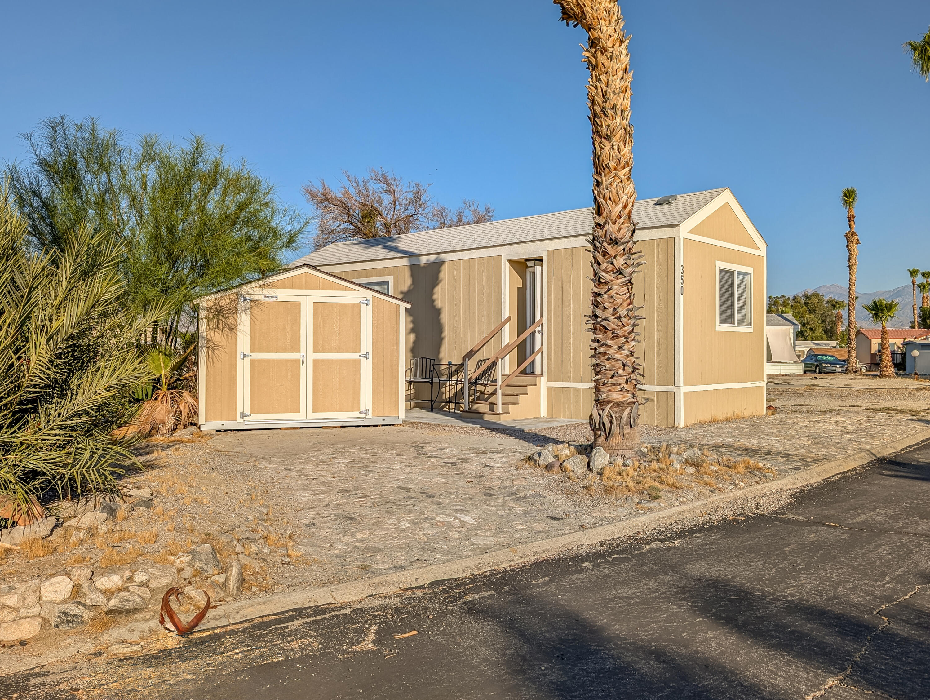 70200 Dillon Road, Unit 350 Desert Hot Springs, CA 92241 - Photo 2 of 22 a front view of a house with a yard