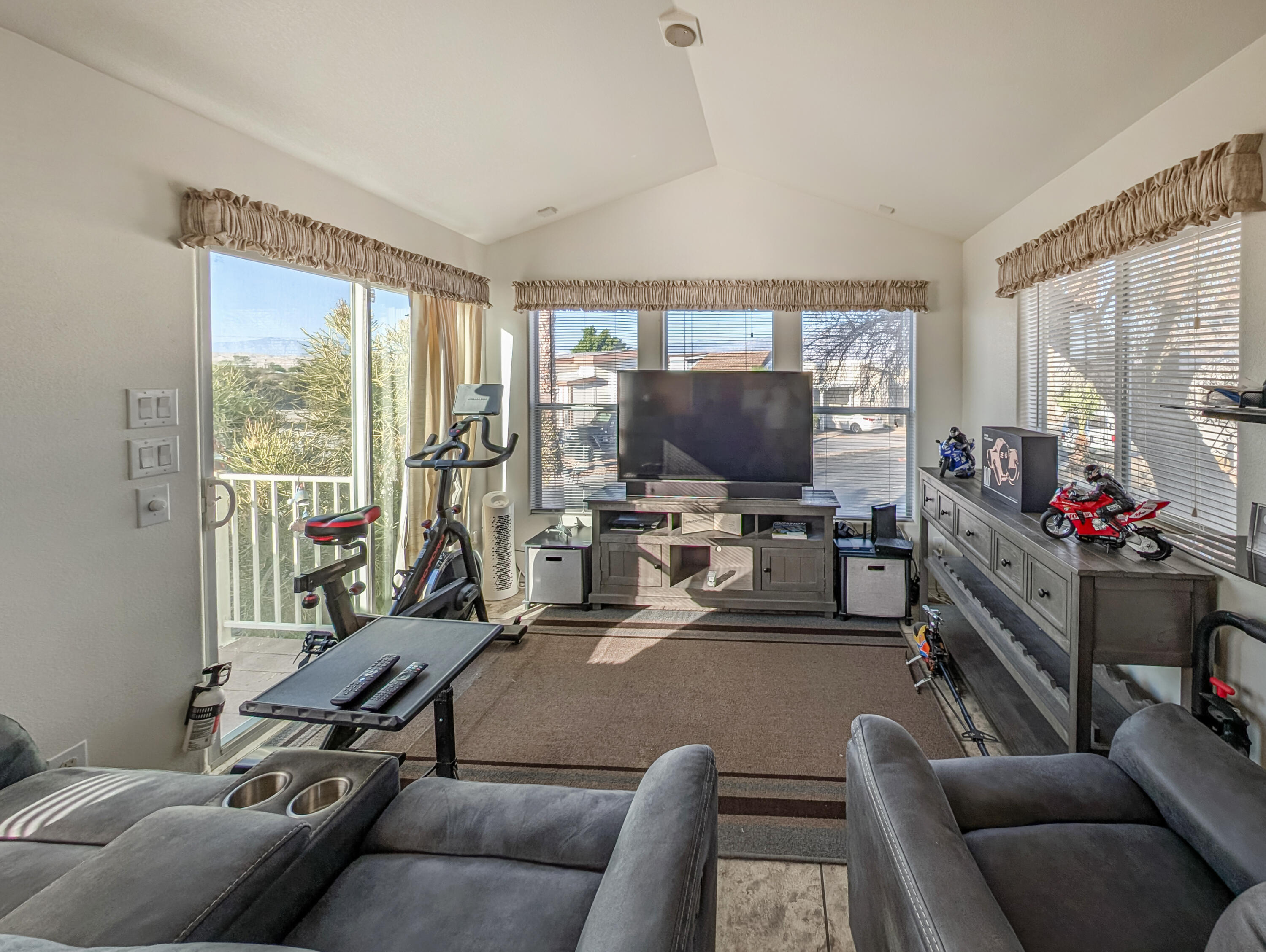 70200 Dillon Road, Unit 350 Desert Hot Springs, CA 92241 - Photo 4 of 22 a living room with furniture a flat screen tv and a floor to ceiling window