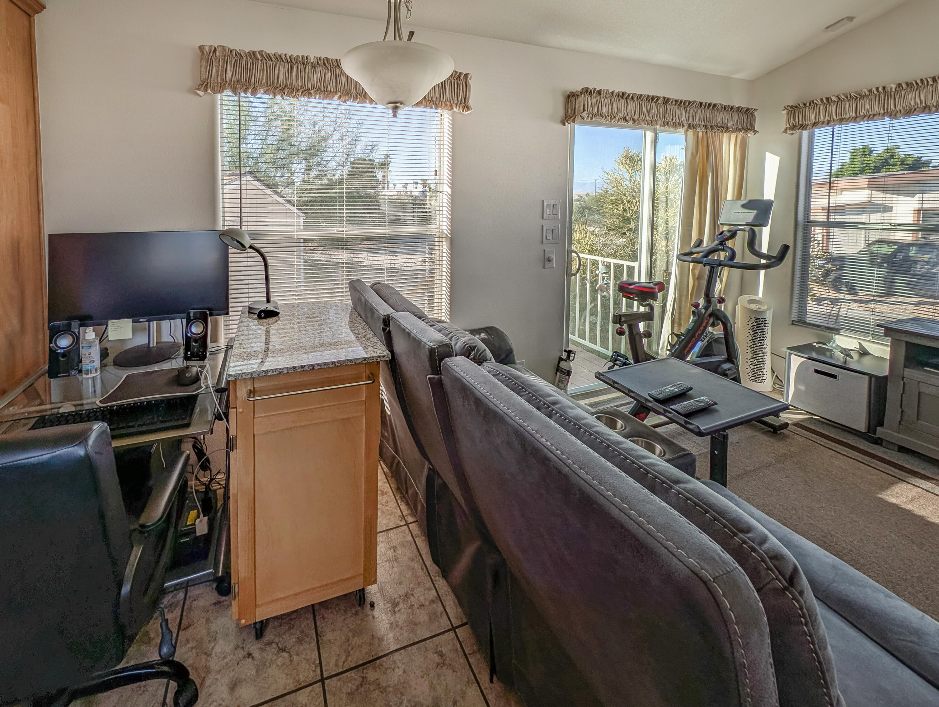 70200 Dillon Road, Unit 350 Desert Hot Springs, CA 92241 - Photo 8 of 22 a room with furniture a flat screen tv and a large window