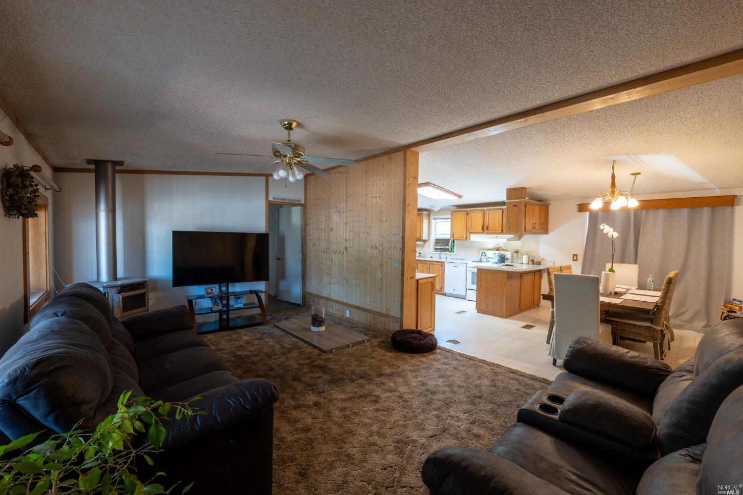 6750 State Highway 20 Ukiah, CA 95482 - Photo 17 of 37 a living room with furniture and a flat screen tv