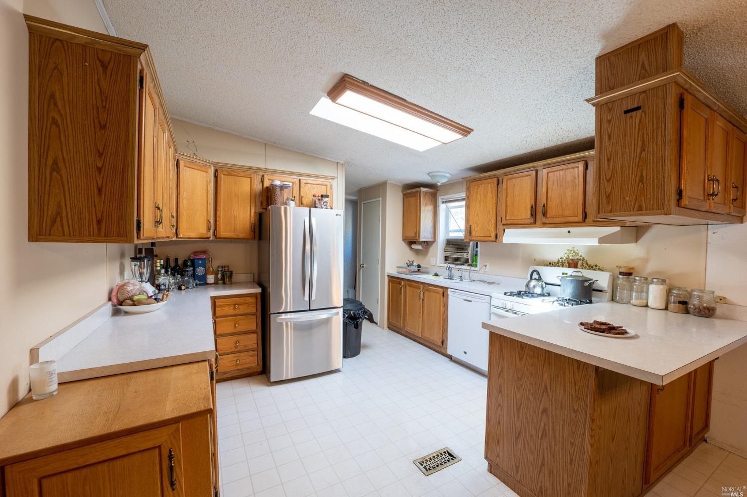 6750 State Highway 20 Ukiah, CA 95482 - Photo 19 of 37 a kitchen with refrigerator and cabinets