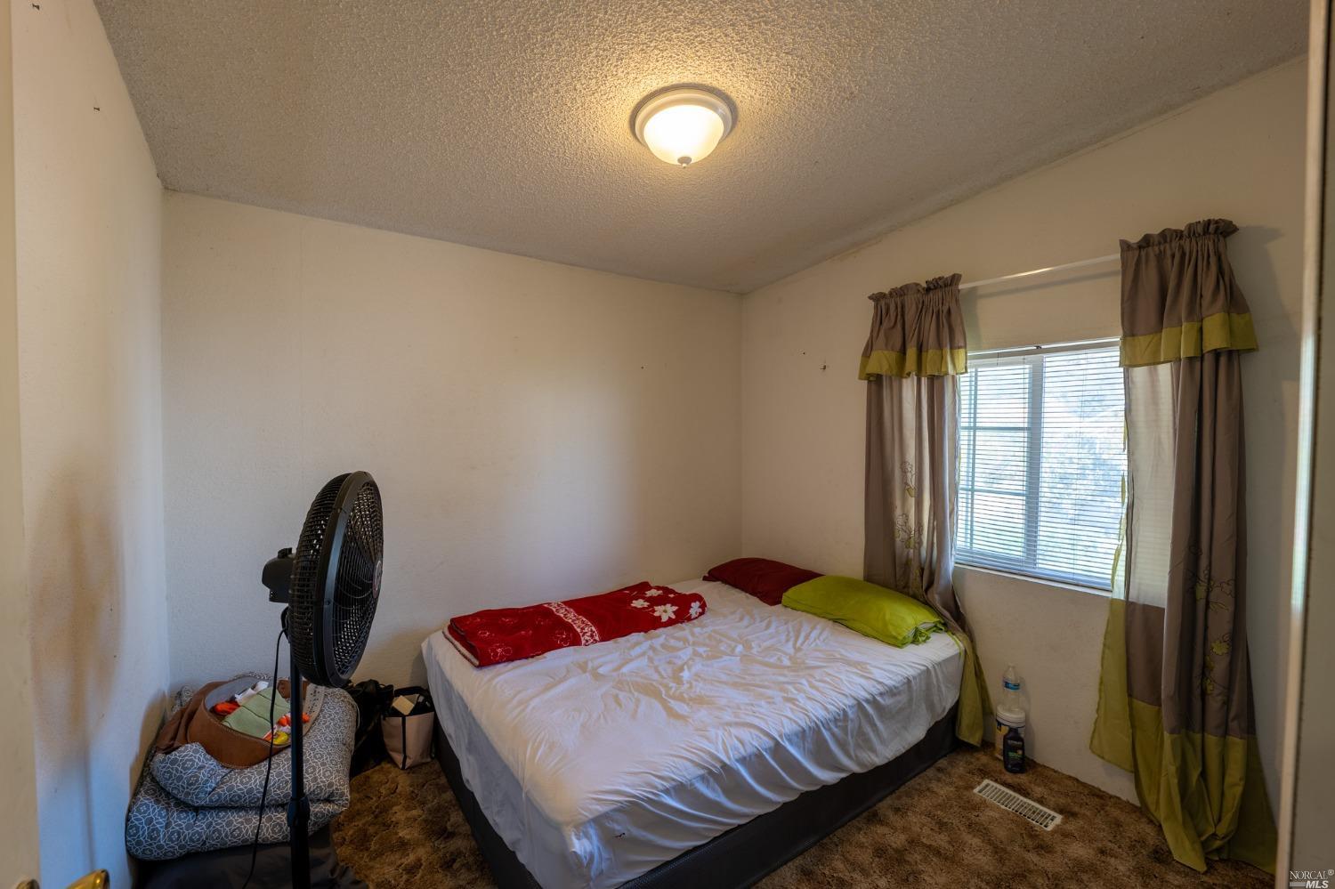 6750 State Highway 20 Ukiah, CA 95482 - Photo 25 of 37 a bedroom with a bed and a window