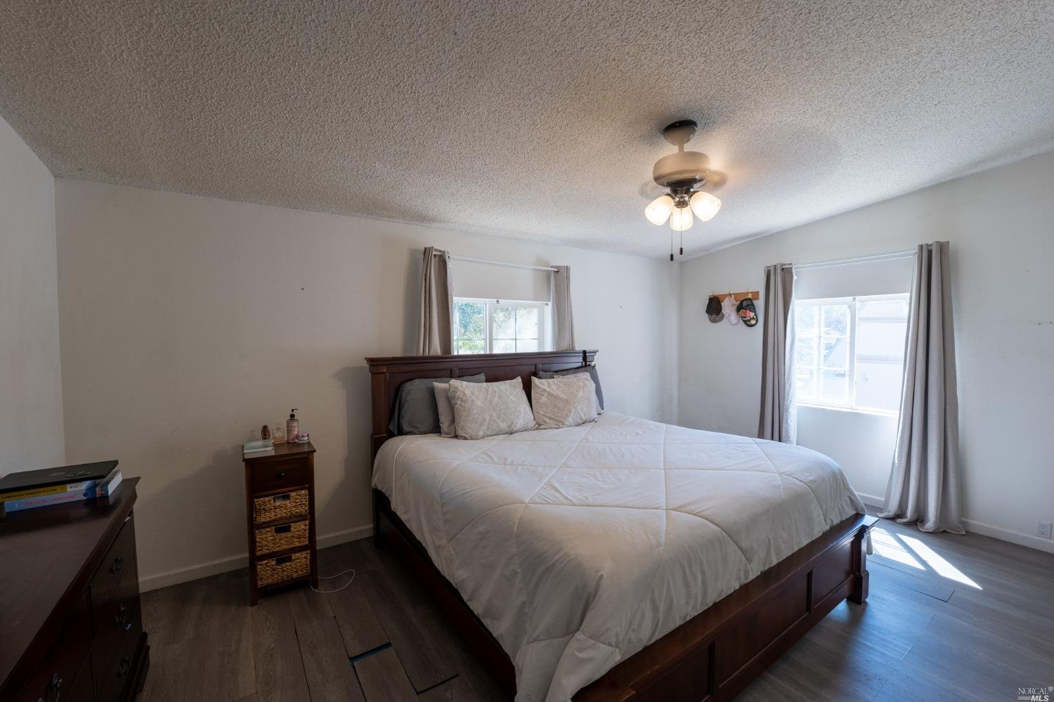 6750 State Highway 20 Ukiah, CA 95482 - Photo 27 of 37 a spacious bedroom with a bed and a chandelier
