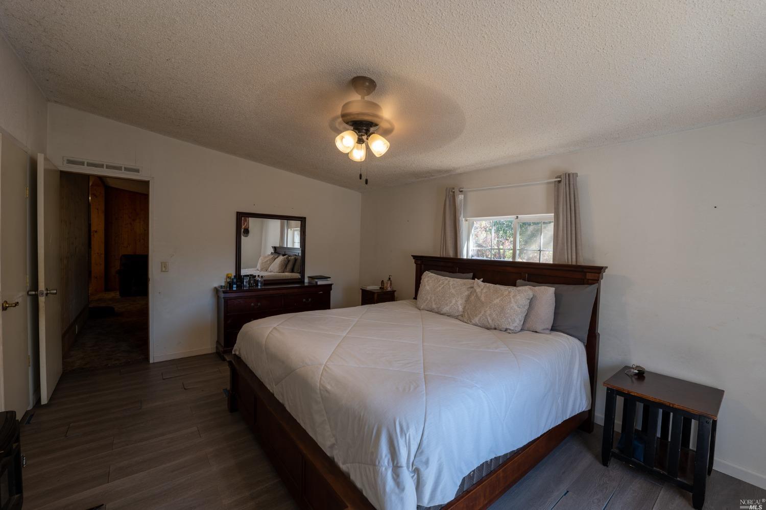 6750 State Highway 20 Ukiah, CA 95482 - Photo 28 of 37 a bedroom with a bed and a chandelier
