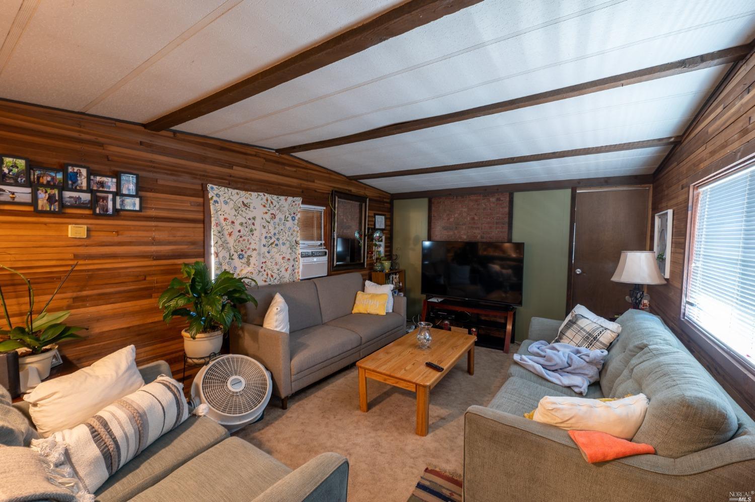 6750 State Highway 20 Ukiah, CA 95482 - Photo 32 of 37 a living room with furniture and a flat screen tv