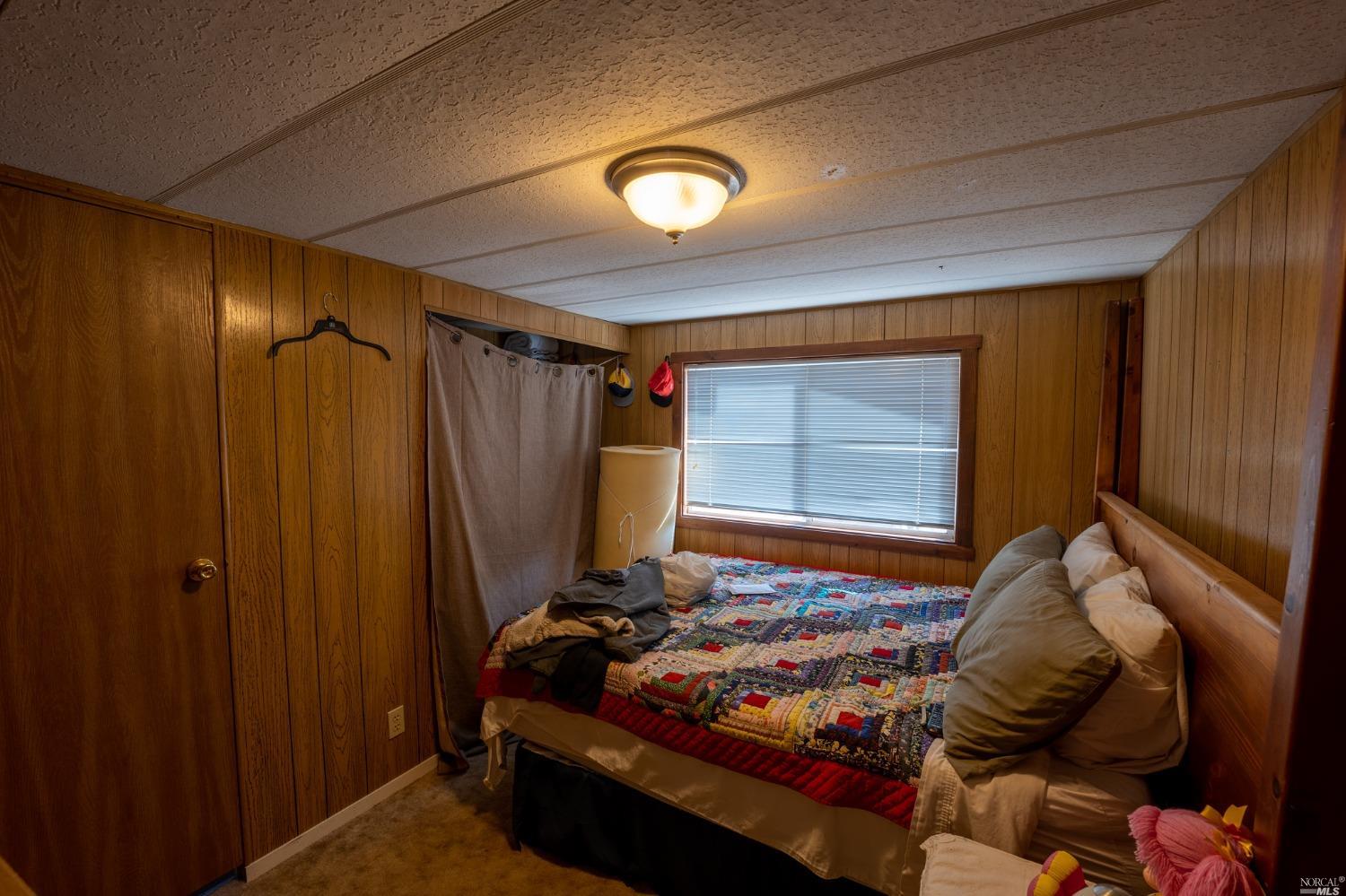 6750 State Highway 20 Ukiah, CA 95482 - Photo 33 of 37 a bed room with a bed and a mirror