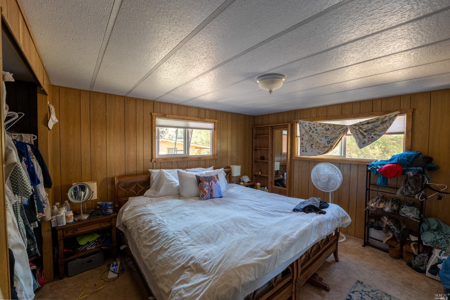 6750 State Highway 20 Ukiah, CA 95482 - Photo 34 of 37 a bedroom with a bed and dresser with wooden floor