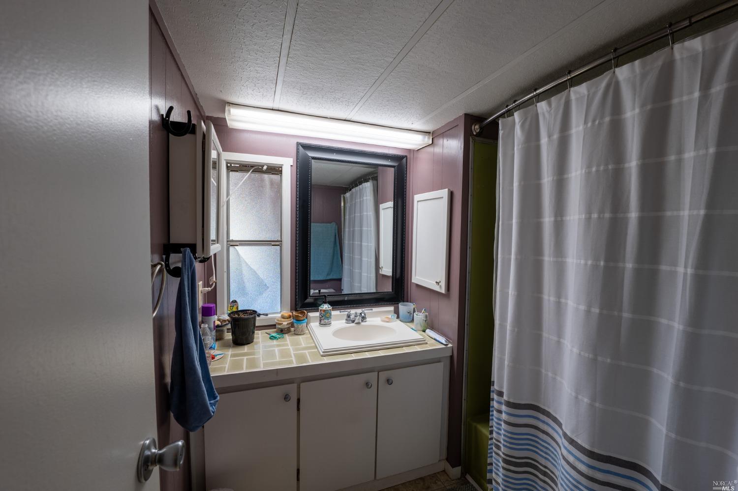 6750 State Highway 20 Ukiah, CA 95482 - Photo 35 of 37 a bathroom with a double vanity sink and mirror
