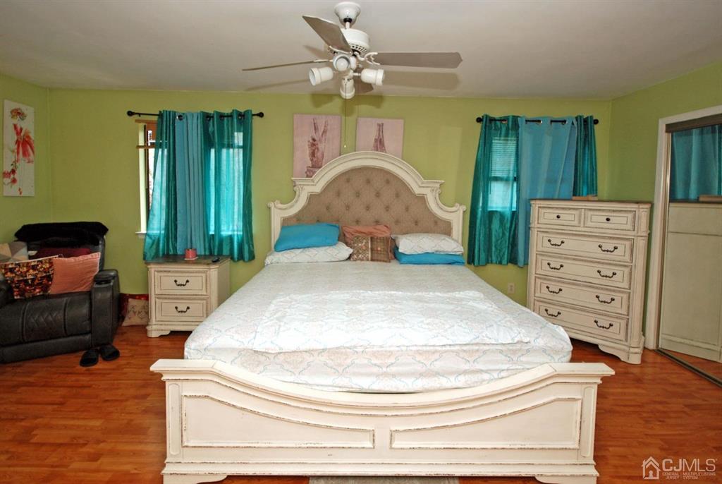 2 Tulip Court Edison, NJ 08820 - Photo 16 of 34 a bedroom with a bed and dresser with mirror