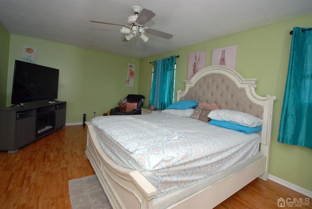 2 Tulip Court Edison, NJ 08820 - Photo 17 of 34 a bedroom with a bed and a flat screen tv