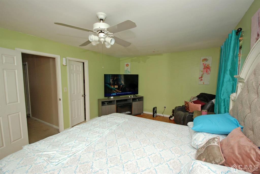 2 Tulip Court Edison, NJ 08820 - Photo 19 of 34 a bedroom with a bed and a flat screen tv