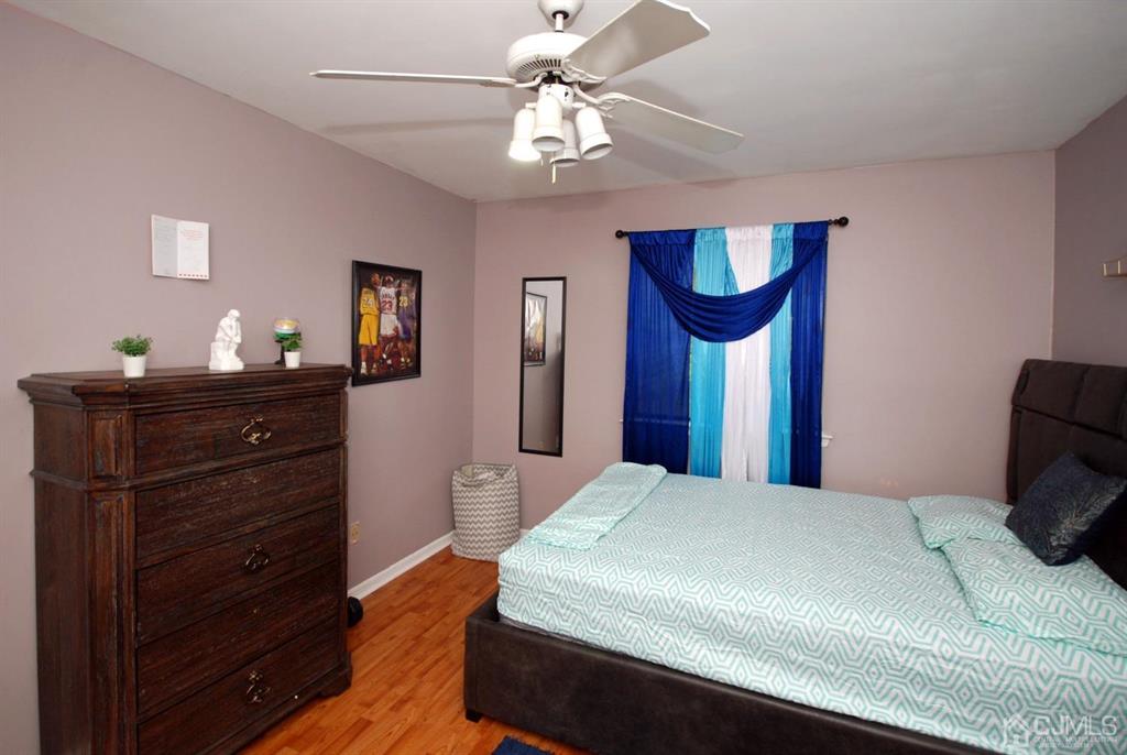 2 Tulip Court Edison, NJ 08820 - Photo 20 of 34 a bedroom with a bed and a chandelier