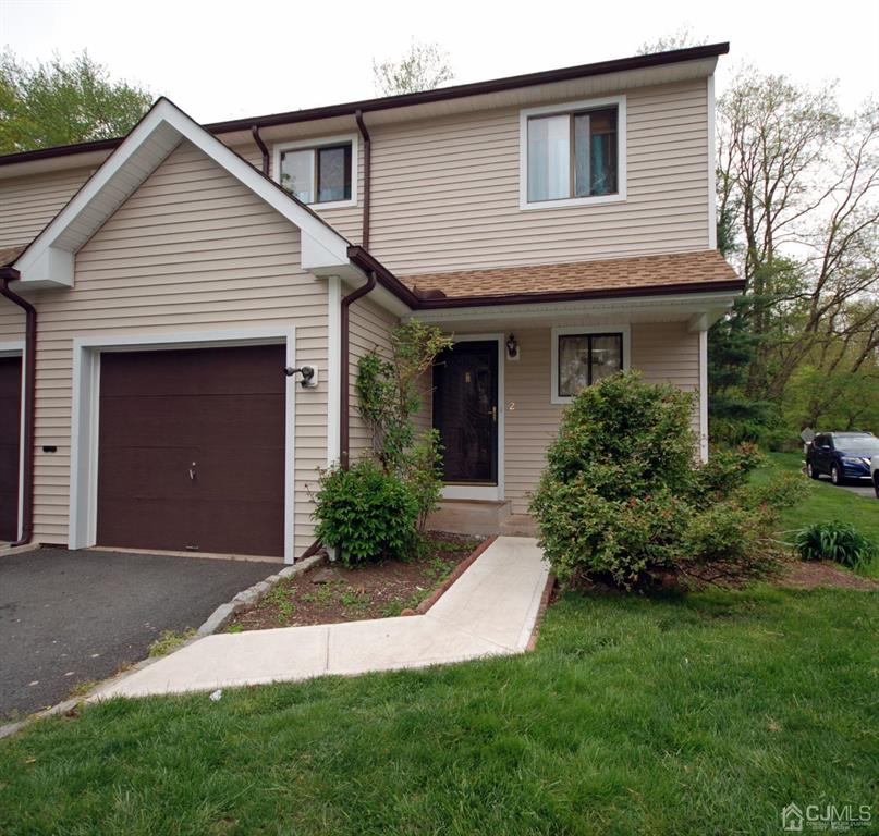 2 Tulip Court Edison, NJ 08820 - Photo 2 of 34 a front view of a house with a garden and plants