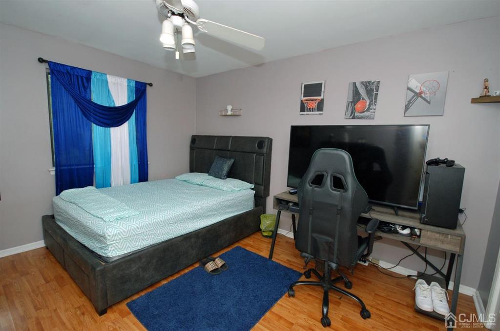 2 Tulip Court Edison, NJ 08820 - Photo 21 of 34 a bedroom with a bed and a chandelier