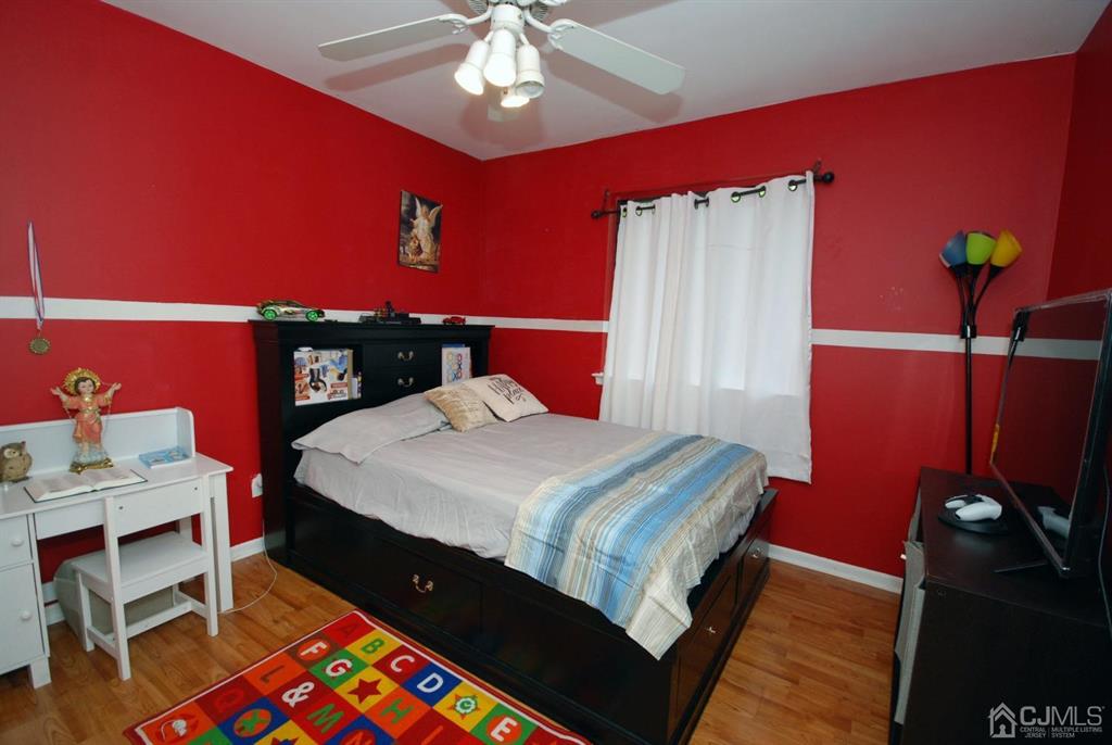 2 Tulip Court Edison, NJ 08820 - Photo 22 of 34 a bed sitting in a bedroom next to a window