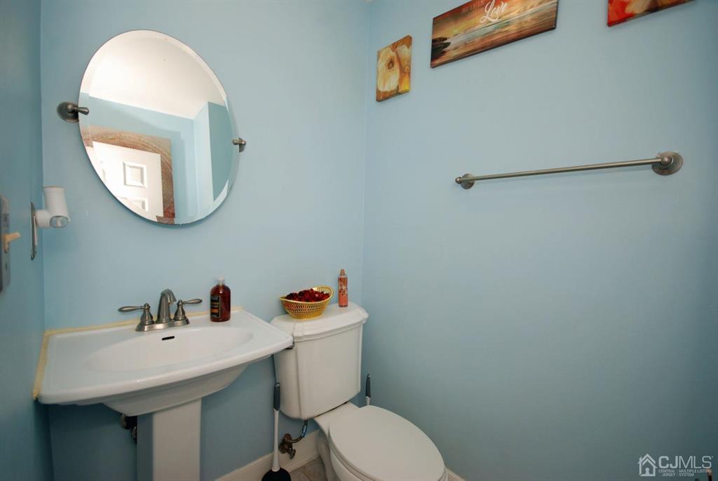 2 Tulip Court Edison, NJ 08820 - Photo 27 of 34 a bathroom with a toilet sink and mirror