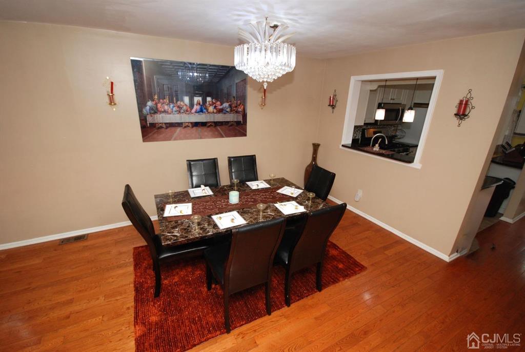 2 Tulip Court Edison, NJ 08820 - Photo 6 of 34 a dining room with furniture and wooden floor