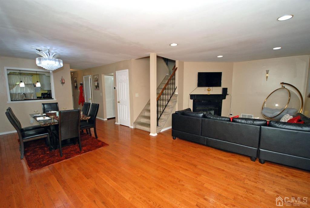 2 Tulip Court Edison, NJ 08820 - Photo 7 of 34 a living room with furniture a flat screen tv and kitchen view